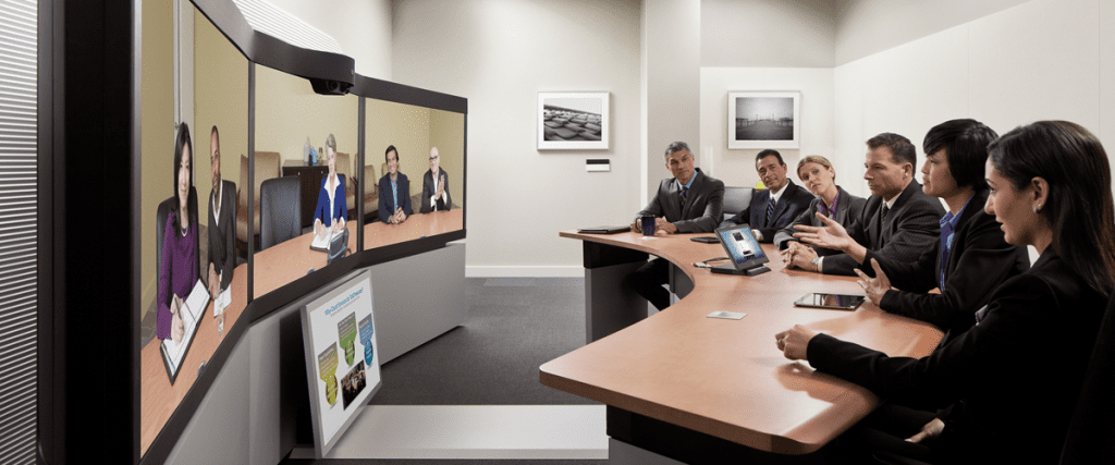 video conferencing in conference room with large screens